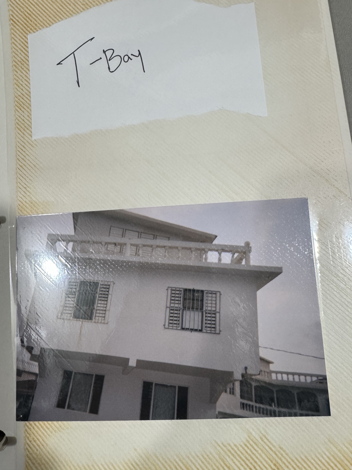 A building photograph mounted beneath a handwritten album label.